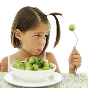child frowning at brussels sprouts