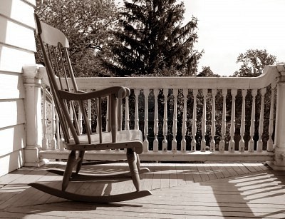 1718009-rocking-chair-on-an-old-house-porch